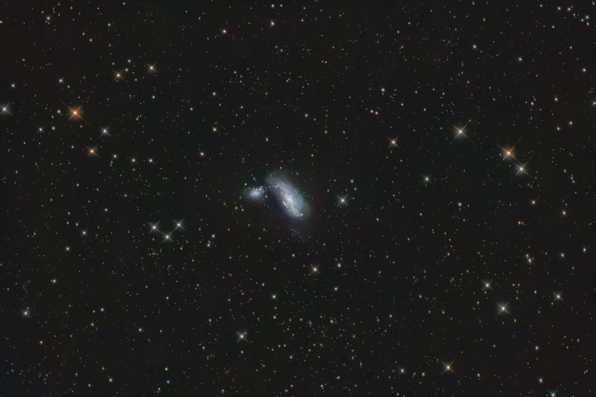 The Cocoon Galaxy ARP269 is an interacting galaxy pair with active star formation regions. The two galaxies are connected by a tidal arm. The center of NGC4490 consists of two separate structures - presumably as a result of a collision of two smaller star clusters. The pair of galaxies is surrounded by diffuse star clouds.